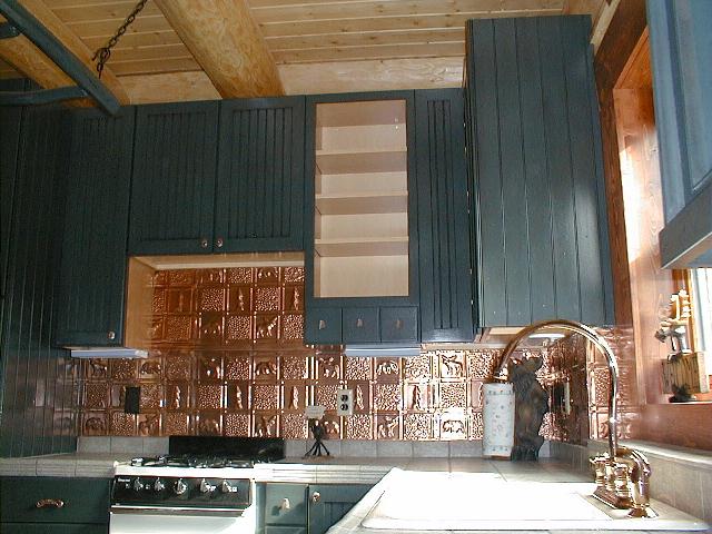 0512 polished copper Blue cabinets with redish backsplash