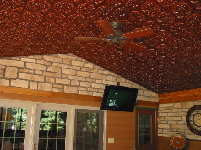 Enclosed patio with french doors, stone walls and antique copper ceilings.