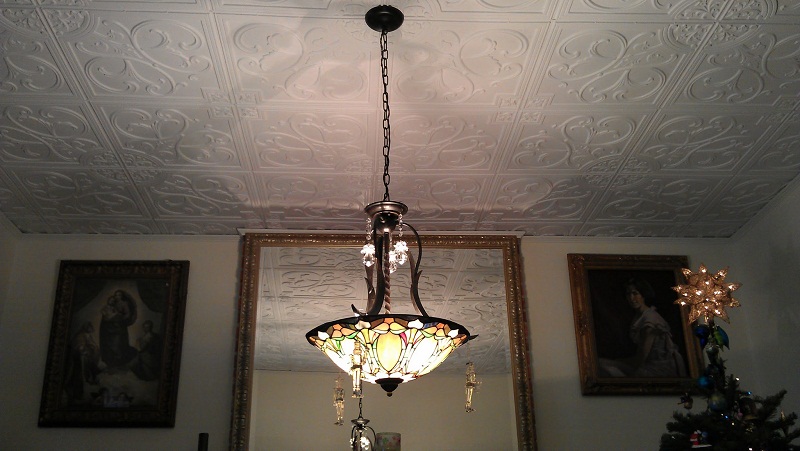 204 White Matte Ceiling Tiles installed on a ceiling with a chandelier and it looks like arround Christams time too.