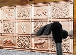 Visual example of how you can hammer in the nails into your metal backsplash.