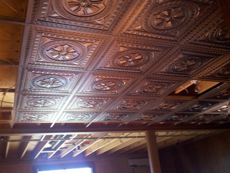 DCT - 01 Antique Copper in Suspended Ceiling Basement Ceiling is getting some face-lift before the Super Bowl with antique copper ceiling tiles inserted into a suspended ceiling.