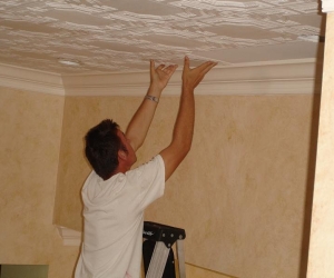 milan-jara-installing-foam-ceiling-tile-in-boca-raton-florida.jpg