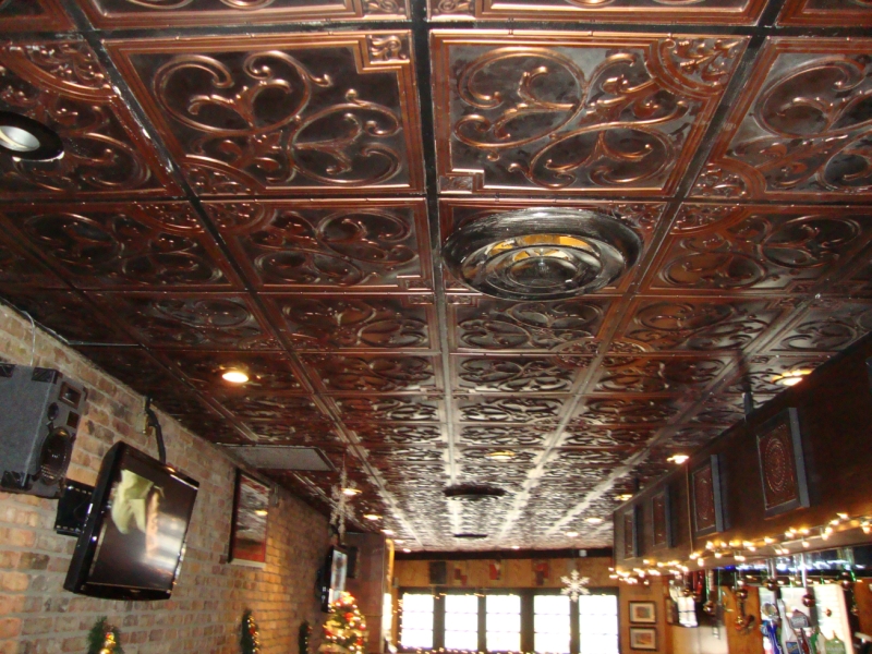 a drop ceiling with decorative ceiling tiles. There is lot of white dust on the ceiling, probably from flour. This is a restaurant and pizzeria.