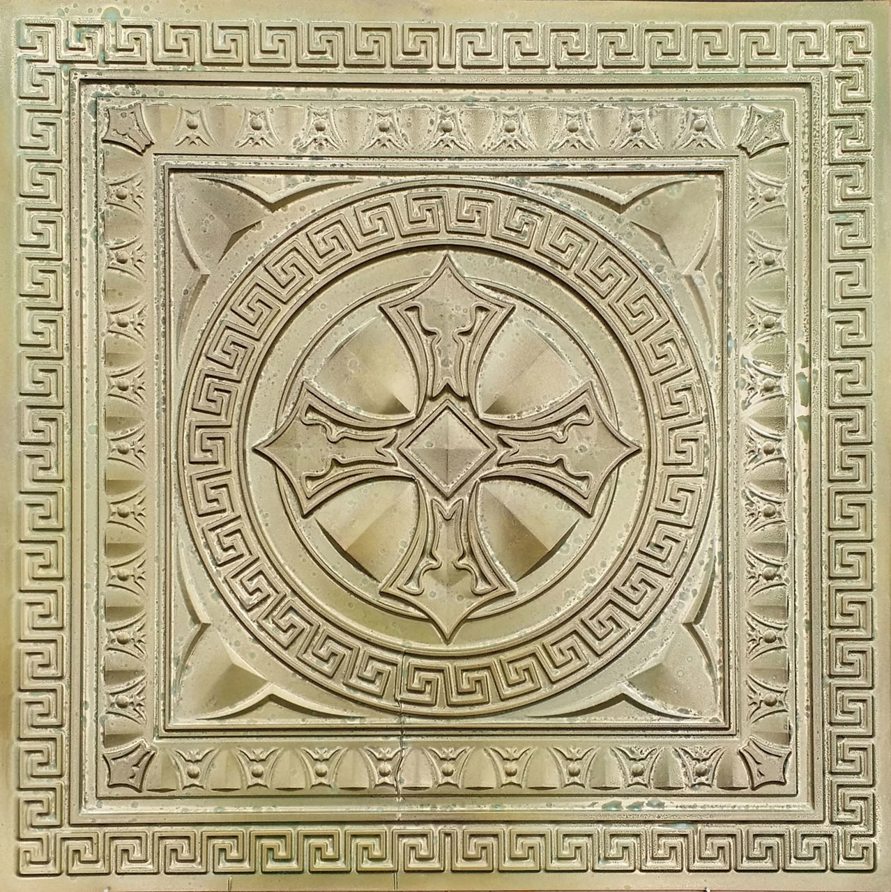 Antique Copper Ceiling Tile with egg and dart design and shield in the middle used as a flooring prop.